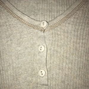 Tight fit long sleeved tee with a few buttons